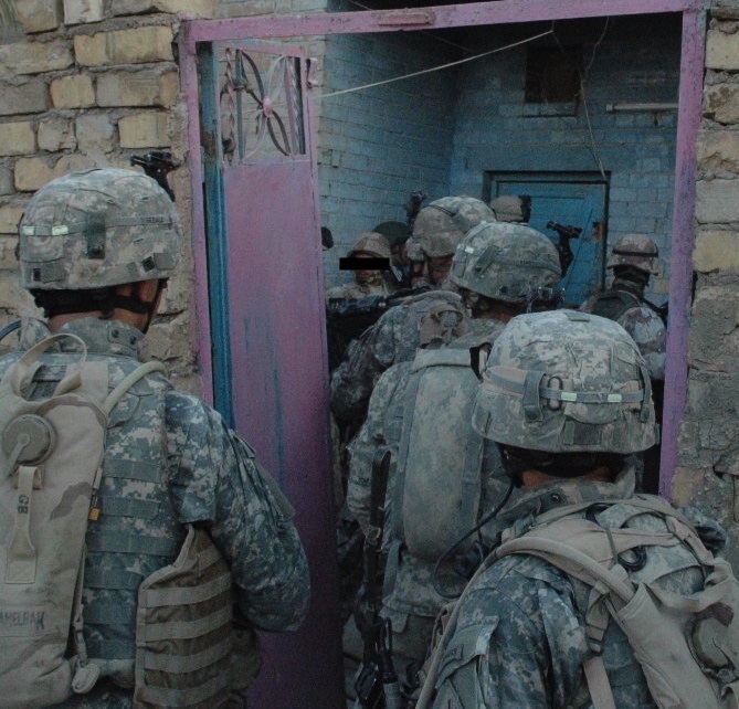 Members of Operational Detachment Thunder, First Armored Division, First Brigade Combat Team, 1/37 Armored Battalion on patrol